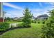 Beautifully landscaped backyard with mature trees and shrubs, offering a serene outdoor space and curb appeal at 7046 Allegiance Ct, Indianapolis, IN 46259