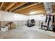 Unfinished basement space featuring concrete floors, exposed ceiling, and an exercise area with fitness equipment at 7046 Allegiance Ct, Indianapolis, IN 46259