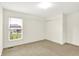 Neutral bedroom with sliding closet doors and a window offering community views and natural light at 7046 Allegiance Ct, Indianapolis, IN 46259