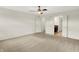 Bright bedroom featuring neutral walls, carpet floors, and ceiling fan with bathroom access at 7046 Allegiance Ct, Indianapolis, IN 46259