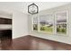 Dining area with a modern light fixture and large windows that provide ample natural light and neighborhood views at 7046 Allegiance Ct, Indianapolis, IN 46259