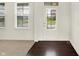 Bright entryway showcasing hardwood floors, a white door, and views of the neighborhood at 7046 Allegiance Ct, Indianapolis, IN 46259