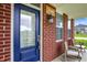 Inviting front porch with seating, a decorative sign, and a stylish blue front door at 7046 Allegiance Ct, Indianapolis, IN 46259