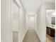 Hallway leads to a bathroom and bedroom in this home's neutral, carpeted interior at 7046 Allegiance Ct, Indianapolis, IN 46259