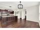 Modern kitchen featuring a large island, stainless steel appliances, and open layout with hardwood floors throughout at 7046 Allegiance Ct, Indianapolis, IN 46259