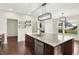 A kitchen with stainless steel appliances, granite countertops, dark wood cabinets, and a spacious island at 7046 Allegiance Ct, Indianapolis, IN 46259