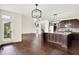 Bright and modern kitchen with stainless steel appliances, a center island, and hardwood floors, open to the living area at 7046 Allegiance Ct, Indianapolis, IN 46259