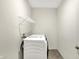 Functional laundry room equipped with a modern washing machine and overhead shelving at 7046 Allegiance Ct, Indianapolis, IN 46259