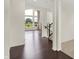 Open-concept living area featuring hardwood floors, a large window, and a staircase at 7046 Allegiance Ct, Indianapolis, IN 46259