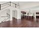 Open-concept living space with hardwood floors, a staircase, and a modern kitchen with stainless steel appliances at 7046 Allegiance Ct, Indianapolis, IN 46259