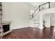 Bright and airy living space featuring hardwood floors, a fireplace, and a staircase leading to the upper level at 7046 Allegiance Ct, Indianapolis, IN 46259
