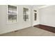 Open-concept living area featuring carpet and hardwood floors and a bright entry with natural light at 7046 Allegiance Ct, Indianapolis, IN 46259