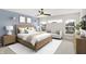 Stylishly staged main bedroom features a bed, sitting area, and a neutral palette complemented by modern lighting at 7046 Allegiance Ct, Indianapolis, IN 46259