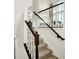 Carpeted staircase with white spindles and a dark wood handrail at 7046 Allegiance Ct, Indianapolis, IN 46259