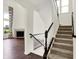 Elegant staircase with a carpet runner leads to an open living area with a fireplace and hardwood floors at 7046 Allegiance Ct, Indianapolis, IN 46259
