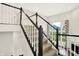 Open staircase featuring carpeted steps and white and wood railing at 7046 Allegiance Ct, Indianapolis, IN 46259