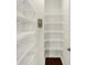 A well-organized walk-in closet is complete with multiple white shelves at 7046 Allegiance Ct, Indianapolis, IN 46259