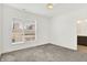 An empty bedroom with neutral carpet, a window and access to the en-suite bathroom at 727 N Illinois St # 202, Indianapolis, IN 46204