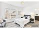 Bedroom with gray carpet, seating, ensuite bathroom, and large windows at 727 N Illinois St # 202, Indianapolis, IN 46204