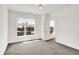This bedroom features neutral carpeting, ample natural light from two windows, and a closet at 727 N Illinois St # 202, Indianapolis, IN 46204