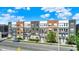 Modern multi-story apartments with balconies and attractive brick and siding facade against a bright blue sky at 727 N Illinois St # 202, Indianapolis, IN 46204