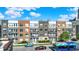 Exterior view of multi-story townhomes, each with balconies and diverse architectural designs at 727 N Illinois St # 202, Indianapolis, IN 46204