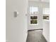 Bright upper hallway with neutral carpet and white walls bathed in sunlight at 727 N Illinois St # 202, Indianapolis, IN 46204