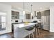 Stylish kitchen with gray cabinets, stainless steel appliances, and a large island at 727 N Illinois St # 202, Indianapolis, IN 46204