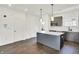 Modern kitchen with gray cabinetry, a white tile backsplash, and a center island at 727 N Illinois St # 202, Indianapolis, IN 46204