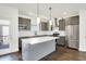Contemporary kitchen featuring gray cabinets, stainless steel appliances, and a kitchen island at 727 N Illinois St # 202, Indianapolis, IN 46204