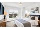 This staged bedroom features a large window and matching night stands and lamps at 727 N Illinois St # 202, Indianapolis, IN 46204