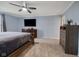 Serene bedroom with ceiling fan, TV, dresser, and carpeted floors at 7319 Jackie Ct, Indianapolis, IN 46221