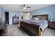 Spacious bedroom featuring carpeted floors, ceiling fan, large bed, and dresser at 7319 Jackie Ct, Indianapolis, IN 46221