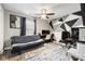 Bedroom featuring modern geometric wall design, with a ceiling fan and futon at 7319 Jackie Ct, Indianapolis, IN 46221