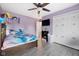 Bright bedroom with a ceiling fan, modern closet doors and purple accent wall at 7319 Jackie Ct, Indianapolis, IN 46221