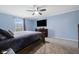 This serene bedroom offers carpeted floor and a mounted TV at 7319 Jackie Ct, Indianapolis, IN 46221