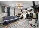 Bedroom featuring modern geometric wall design, with a ceiling fan and futon at 7319 Jackie Ct, Indianapolis, IN 46221