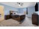 Comfortable bedroom with carpet, a ceiling fan, and a wooden framed bed and dresser at 7319 Jackie Ct, Indianapolis, IN 46221