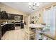 Bright dining room with a modern chandelier, window and adjacent kitchen at 7319 Jackie Ct, Indianapolis, IN 46221