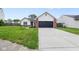 Exterior view of home displaying attached garage, walkway, and front yard at 7319 Jackie Ct, Indianapolis, IN 46221