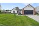 Charming single-story home with a well-maintained lawn and attached two car garage at 7319 Jackie Ct, Indianapolis, IN 46221