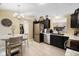 This well-lit kitchen has stainless steel appliances, dark wood cabinets, and a tiled floor with a dining table at 7319 Jackie Ct, Indianapolis, IN 46221
