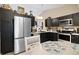 This modern kitchen features stainless steel appliances and dark wood cabinets and dining area with circular wooden table at 7319 Jackie Ct, Indianapolis, IN 46221