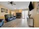 Comfortable living room with a fireplace, sliding glass doors, and a ceiling fan at 7319 Jackie Ct, Indianapolis, IN 46221