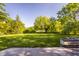 Manicured backyard with lake view surrounded by mature shade trees at 734 Richland Way, Westfield, IN 46074