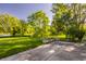 Green backyard with mature trees and lake view from concrete patio at 734 Richland Way, Westfield, IN 46074