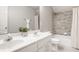 Bathroom with double sinks, large mirror, shower, and tiled walls at 734 Richland Way, Westfield, IN 46074