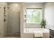 Beautiful bathroom with a glass shower and a tub next to a large window at 734 Richland Way, Westfield, IN 46074