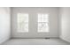 A well lit empty bedroom with gray carpet and two windows at 734 Richland Way, Westfield, IN 46074