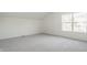An empty bedroom with gray carpet and a bright window at 734 Richland Way, Westfield, IN 46074